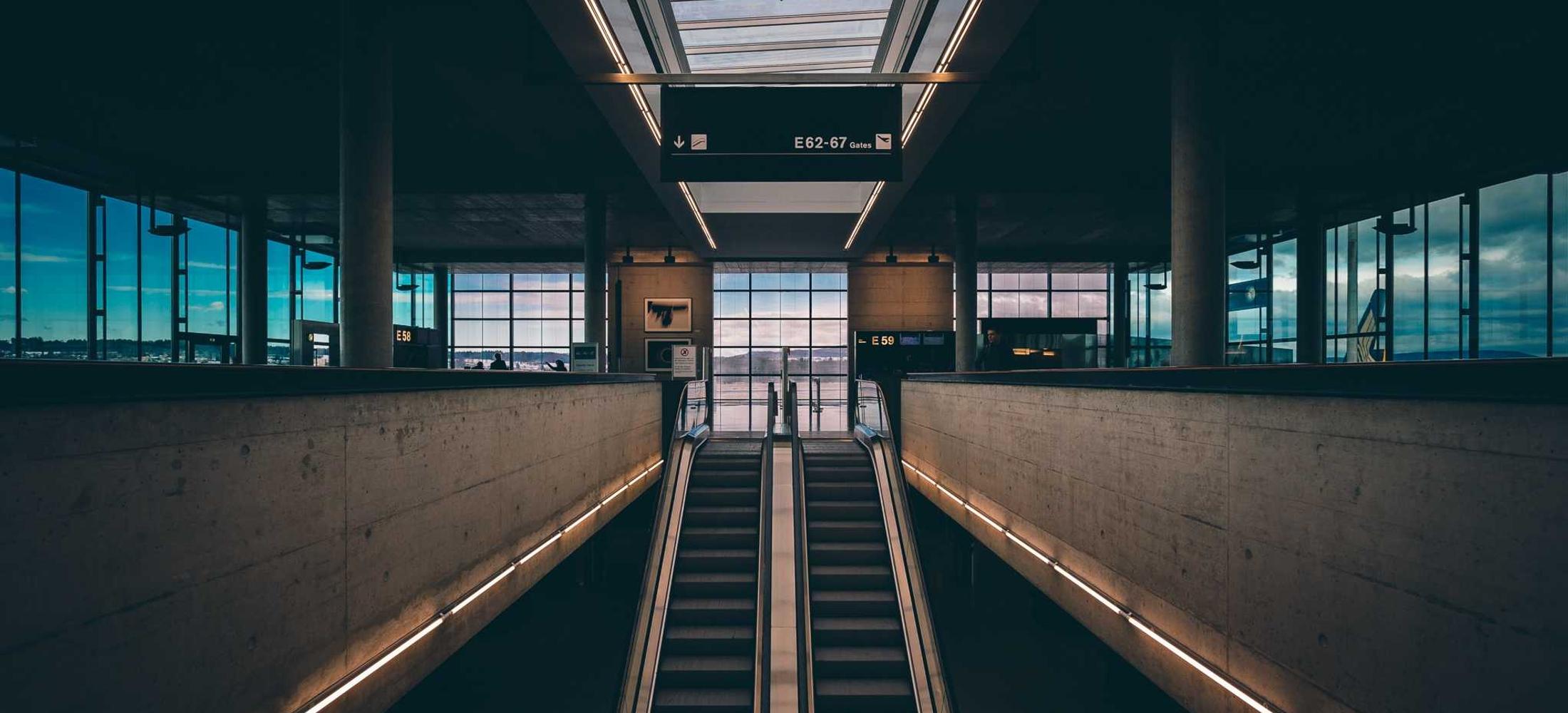 A terminal concourse receding in symmetrical perspective